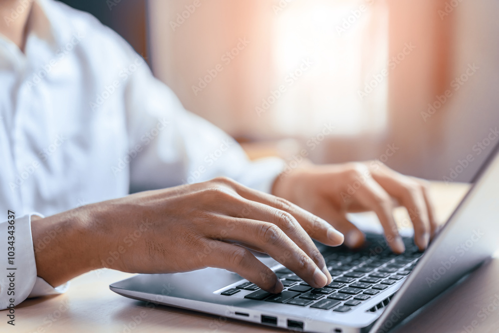 Businessman hand typing on computer keyboard of a laptop computer in office. Business and finance concept. uds Businessman hand typing on computer keyboard of a laptop computer in office. Business and finance concept. uds