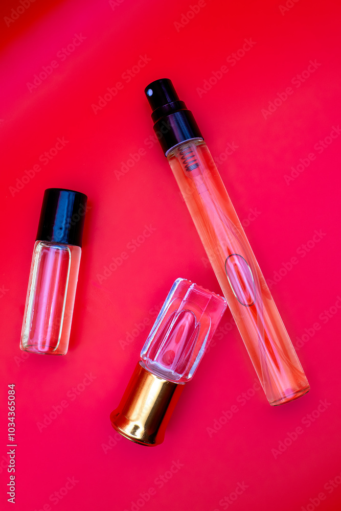 Bottles for fragrances. Red Background. Women's perfume, fragrant oil with Place for your text Bottles for fragrances. Red Background. Women's perfume, fragrant oil with Place for your text