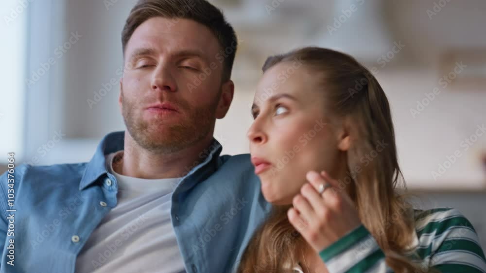 Couple hands taking popcorn from glass bowl at home closeup. Lovers watching tv Couple hands taking popcorn from glass bowl at home closeup. Lovers watching tv