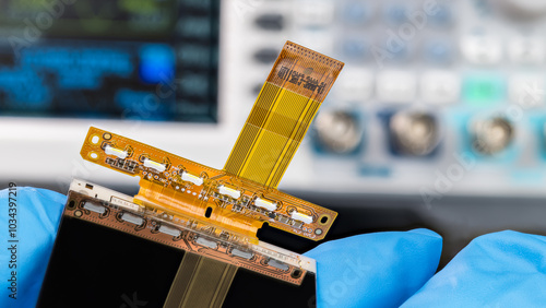 Canvas Print Close-up a mobile phone flex printed circuit with flat cable in repairman hand