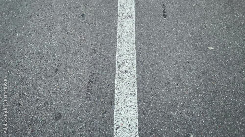 White Lines Of Road Markings On Gray Asphalt. Traffic Rules. Arrow sign on the asphalt White Lines Of Road Markings On Gray Asphalt. Traffic Rules. Arrow sign on the asphalt