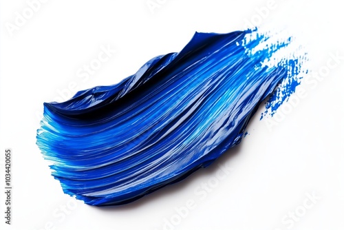 Blue paint stroke with smooth, flowing texture and subtle splashes on a white background, evoking a sense of motion and creativity