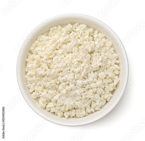 Bowl of cottage cheese isolated on white background, top view