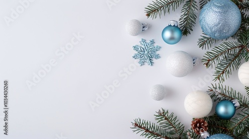 Blue and white Christmas ornaments, pine branches, snowflakes on a white background, minimalist holiday decor, festive arrangement, winter vibes, clear copyspace for text.