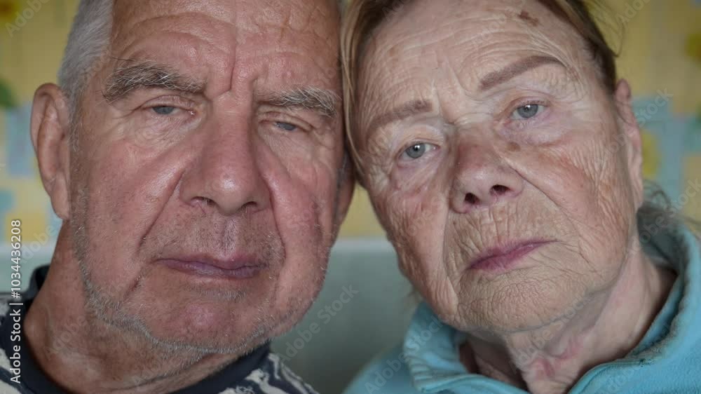 Couple faces close up. Deep wrinkles on face. Elderly couple standing close together, showcasing calm of subtle facial expressions. Persons look at camera. Family in old age Couple faces close up. Deep wrinkles on face. Elderly couple standing close together, showcasing calm of subtle facial expressions. Persons look at camera. Family in old age