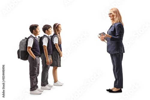 Full length shot of teacher talking to a group of schoolchildren photo