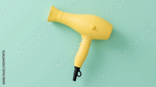 A sleek yellow hair dryer on a soft green surface, ready for use in a personal care routine at home