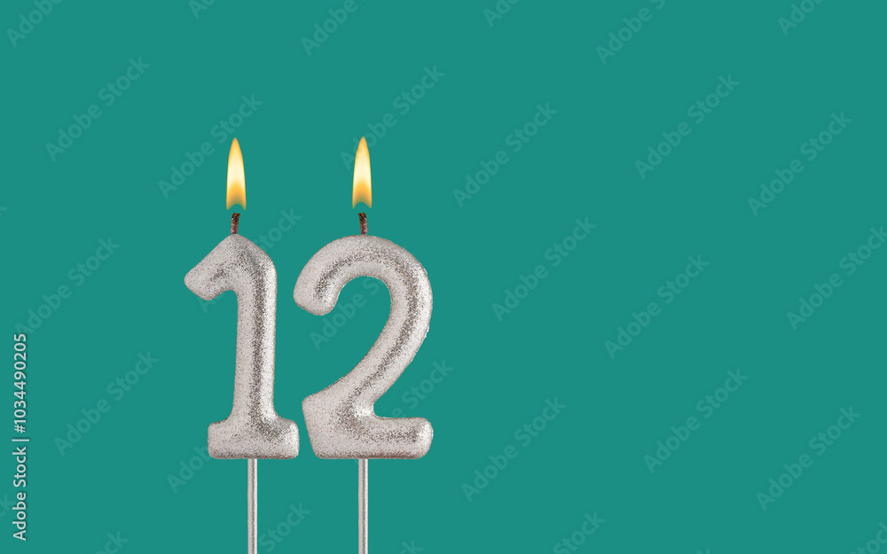 Birthday candle number 12 - Card on a green background.