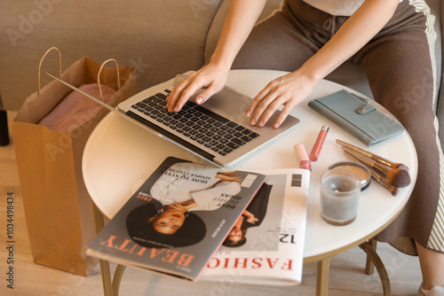 Woman with laptop and makeu...
