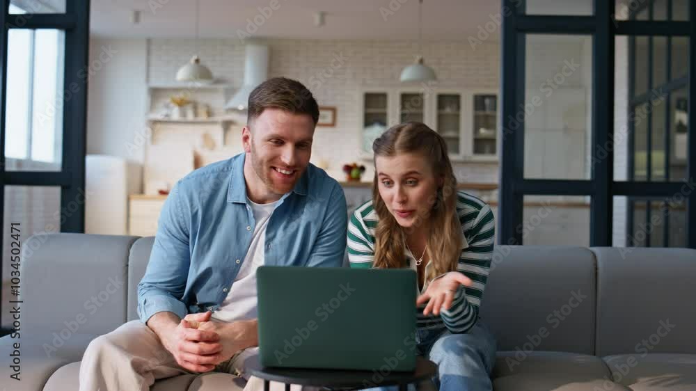 Smiling couple video calling sitting couch closeup. Happy spouses looking laptop Smiling couple video calling sitting couch closeup. Happy spouses looking laptop