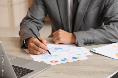 Papier peint Male economist working with diagrams at desk in office, closeup