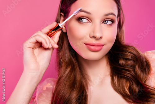 Close up photo of adorable cute lady prepare for event applying styling gel for brows empty space on pink background photo