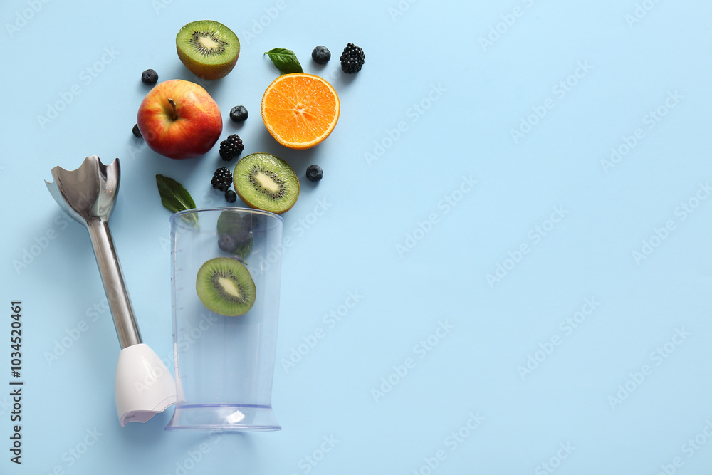 Modern blender with fruits and berries on blue background Modern blender with fruits and berries on blue background