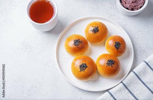 Red bean paste buns with black sesame seeds sprinkles