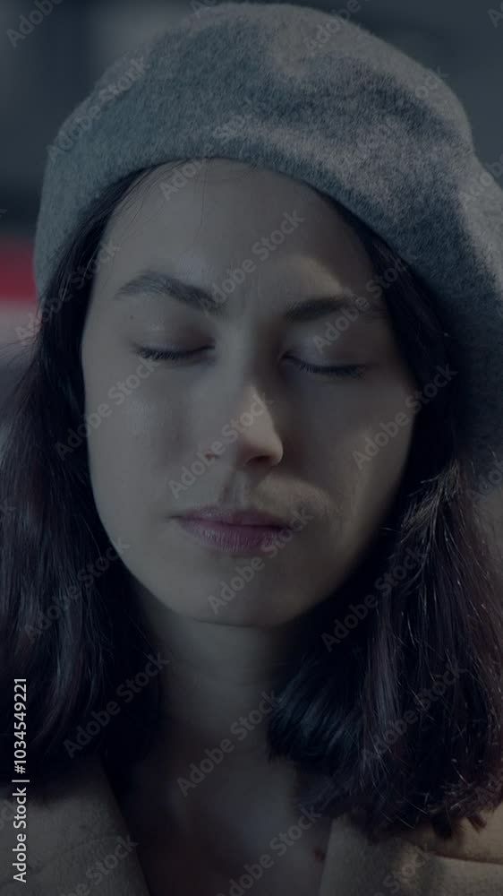 A Contemplative Woman Wearing a Chic Beret with Her Eyes Gently Closed, Lost in Thought A Contemplative Woman Wearing a Chic Beret with Her Eyes Gently Closed, Lost in Thought