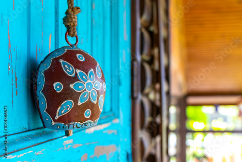 Hanging cowbell on the turquoise blue door in Costa Rica. photo