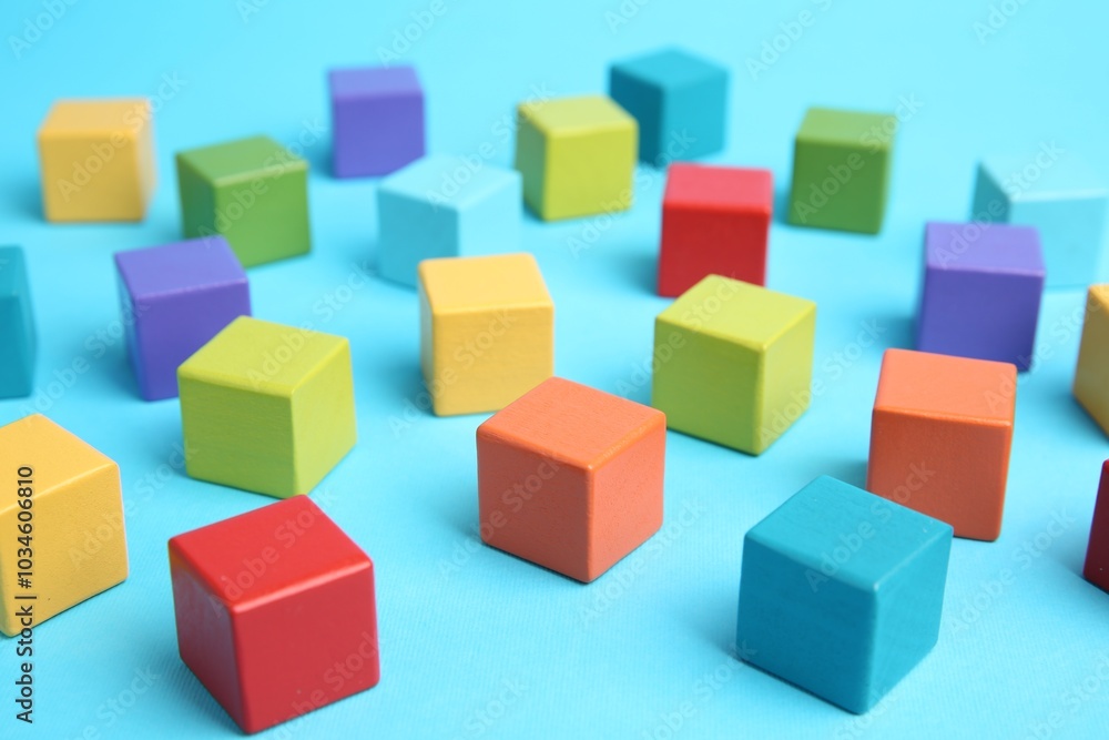 Many colorful cubes on light blue background Many colorful cubes on light blue background