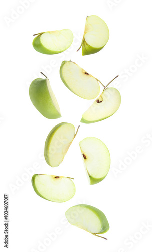 Sliced green apples in air on white background