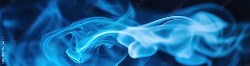 Obraz premium Abstract blue smoke wisps against a black background, creating a ethereal and artistic design.