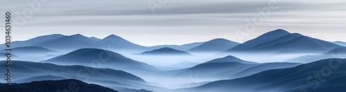 Misty mountains with soft, blue hues and a sense of serenity.