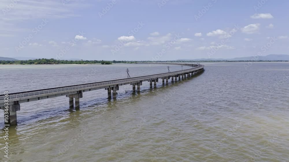 Aerial view of Thai local train on railway bridge at Pa Sak Jolasid Dam, the biggest reservoir in central Thailand, in Lopburi province with sea shore in transportation and travel concep Aerial view of Thai local train on railway bridge at Pa Sak Jolasid Dam, the biggest reservoir in central Thailand, in Lopburi province with sea shore in transportation and travel concep