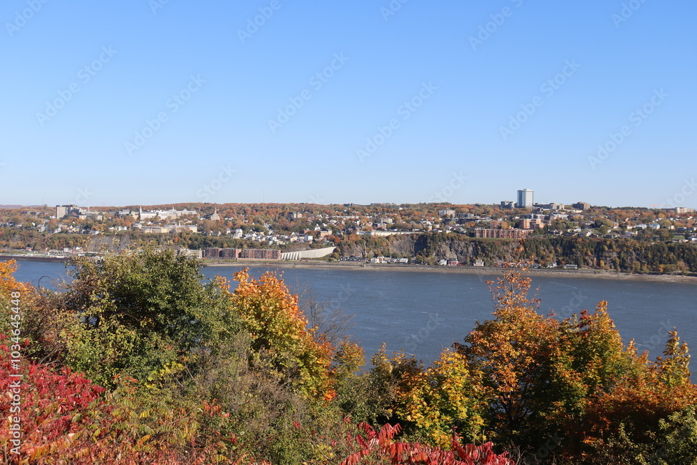 Fototapeta premium Autumn landscape and travel in Quebec city. A riverside of Quebec city with a view in october of Levis or the south riverside of Quebec. Cityscape and october calendar. 