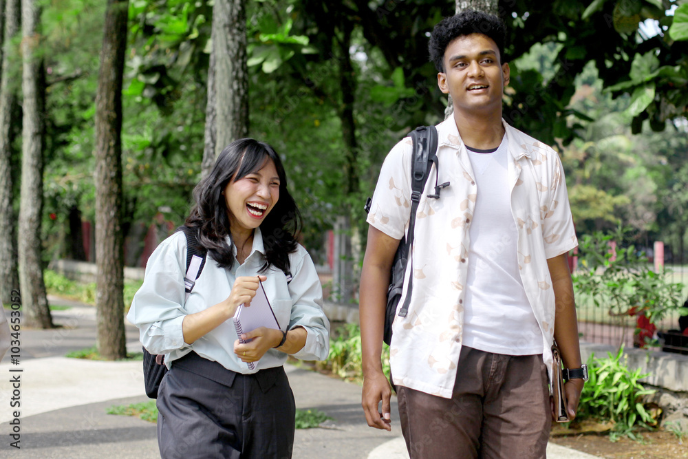 Cheerful Asian College Students Carrying backpack And Walking Near Campus Building Outdoors Cheerful Asian College Students Carrying backpack And Walking Near Campus Building Outdoors