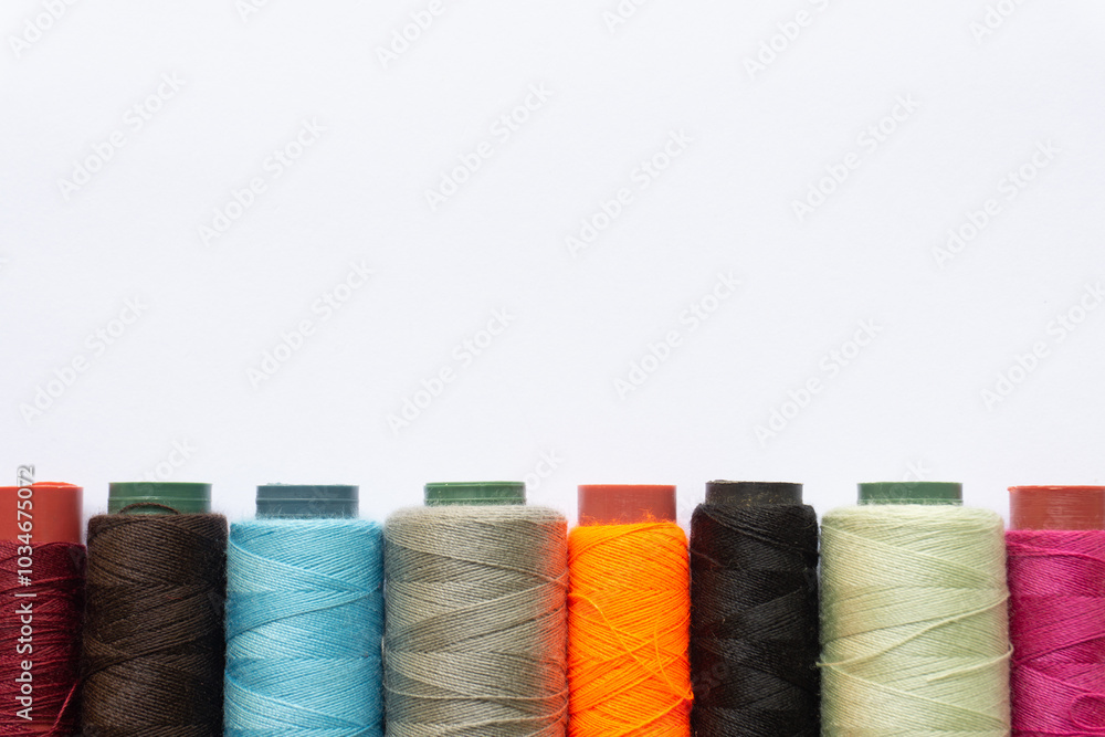 Top view of colorful threads on white background with various layouts. Top view of colorful threads on white background with various layouts.