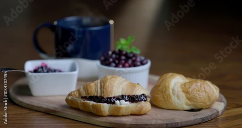 Wallpaper Mural A plate of croissants and a cup of coffee sit on a wooden cutting board. The croissants are arranged in a way that they look like they are ready to be eaten with fresh wild berry jam. Torontodigital.ca