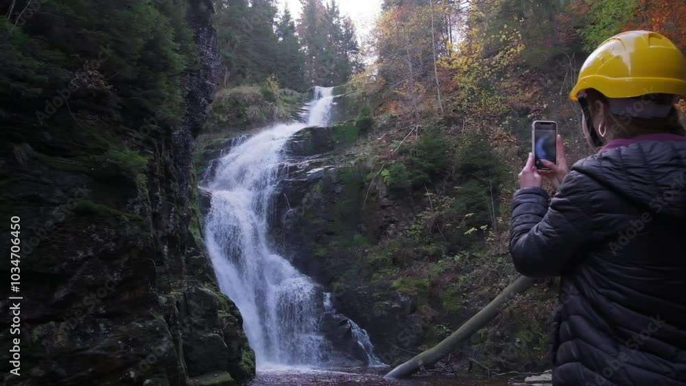 A serene video shows a woman and a friend enjoying a waterfall A serene video shows a woman and a friend enjoying a waterfall