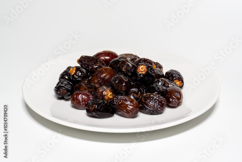 Dried dates on white background. Premium quality date fruit isolated on a plate. Date fruit with white background.