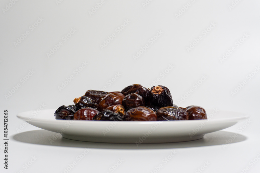 Dried dates on white background. Premium quality date fruit isolated on a plate. Date fruit with white background. Dried dates on white background. Premium quality date fruit isolated on a plate. Date fruit with white background.