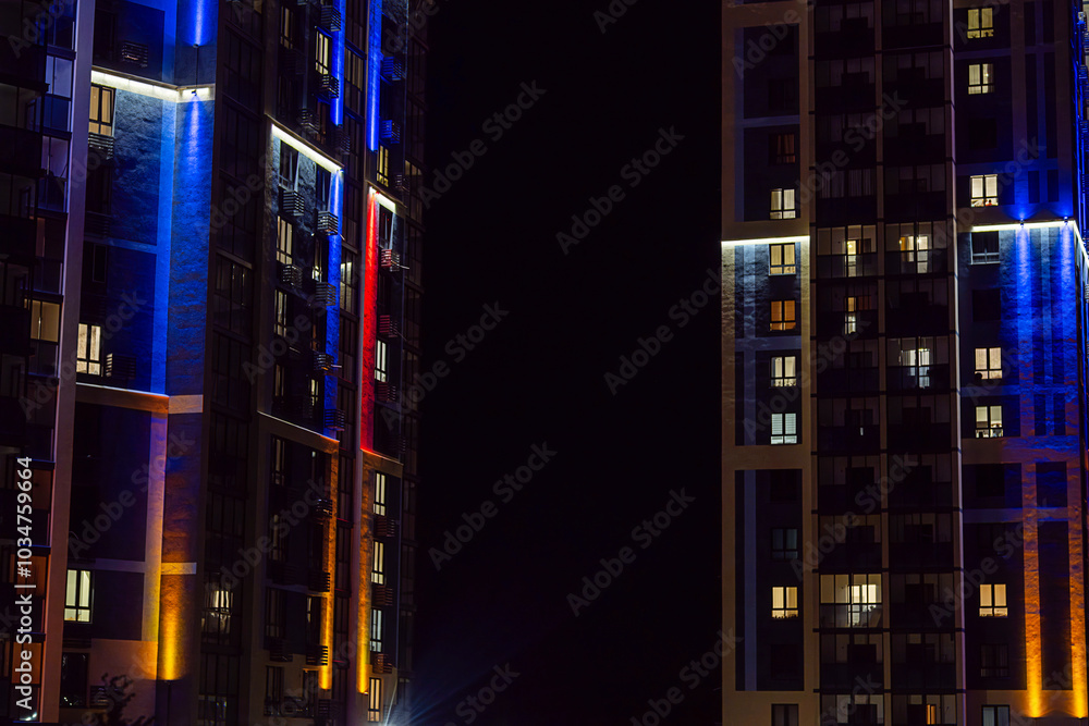 Illuminated multistory apartment building at night. City life concept. Illuminated multistory apartment building at night. City life concept.