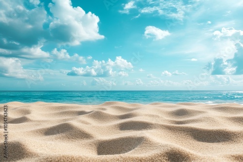 Sandy beach with blue ocean and sky, perfect for summer vacation.