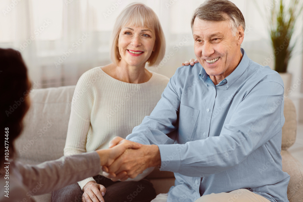 Obraz premium Nice To Meet You. Young female therapist meeting elderly couple for a counselling session, greeting with handshake