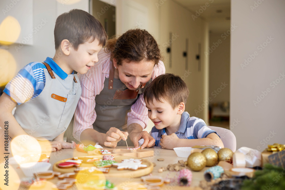 Obraz premium Happy family mother and children in aprons making Christmas cookies together while cooking
