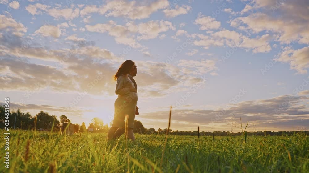 Expecting parents enjoy a sunset stroll in a peaceful countryside field Expecting parents enjoy a sunset stroll in a peaceful countryside field