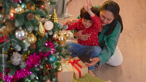 multi generation asian family grandfather and grandmom with nephew child boy prepare christmas eve thanksgiving party together decorate setting living room with christmas tree while spending time