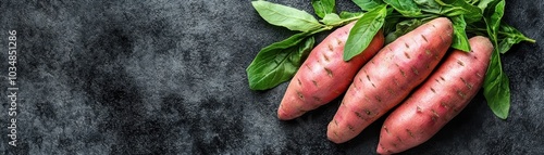 Fresh Organic Sweet Potatoes with Green Leaves on Dark Rustic Background - Healthy Vegetarian Food Concept photo