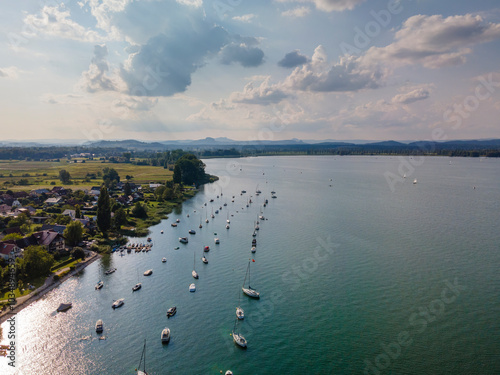 Top view to Bodensee village Iznang during summer time with sailboats at the pier for vacation pleasure photo