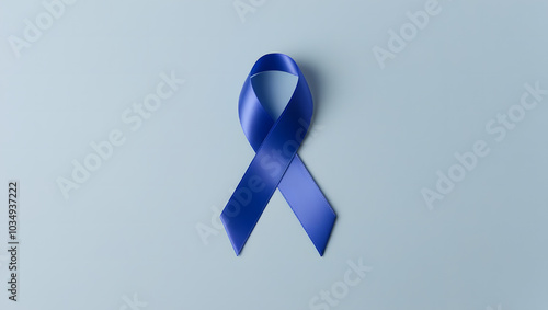 Blue awareness ribbon isolated on blue background. World diabetes day, 14 november, prostate cancer awareness banner. Blue November, International Men's Day concept with copy space photo