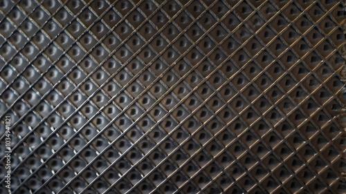 a metal flooring pattern viewed from above, featuring interlocking geometric shapes such as hexagons and triangles. 