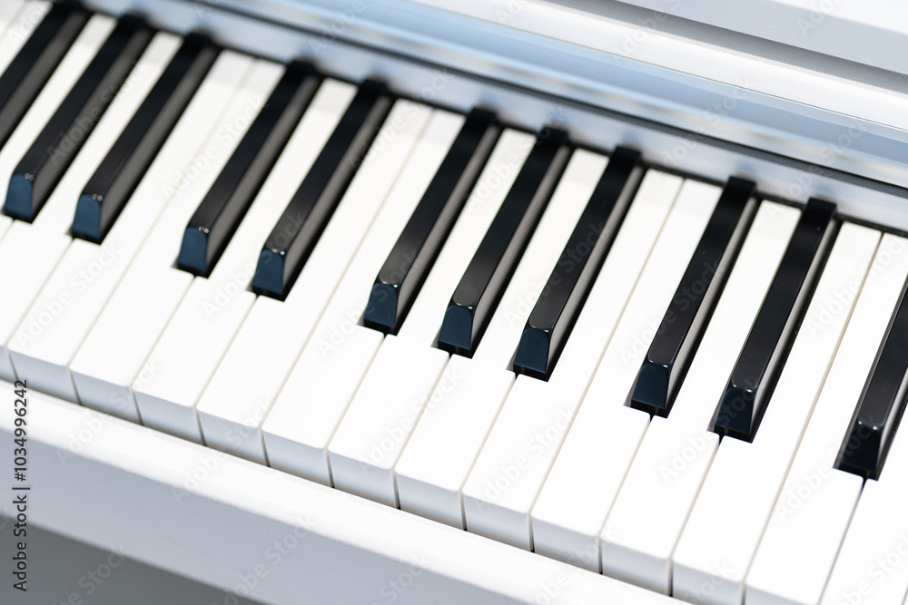 Black and white keys on a white electronic piano. Piano keys closeup. Classic piano keyboard. Black and white keys on a white electronic piano. Piano keys closeup. Classic piano keyboard.