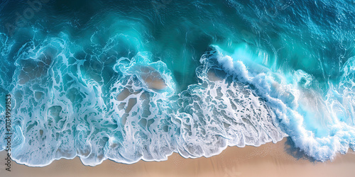 Aerial view of tropical beach shore with a blue ocean, waves. Overhead photo of crashing waves on the shoreline beach.