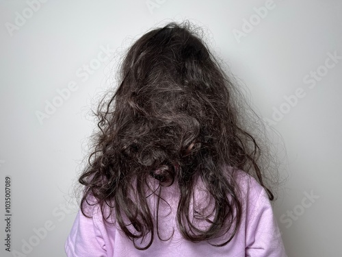 Wild curly black tangled hair of a little girl view from the back of the head – Kids with Curly Hair Maintenance and Grooming Abstract Background