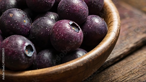Wallpaper Mural A close-up of nutrient-rich Brazilian açaí berries in a rustic wooden bowl, showcasing their deep purple hue and superfood status. Torontodigital.ca