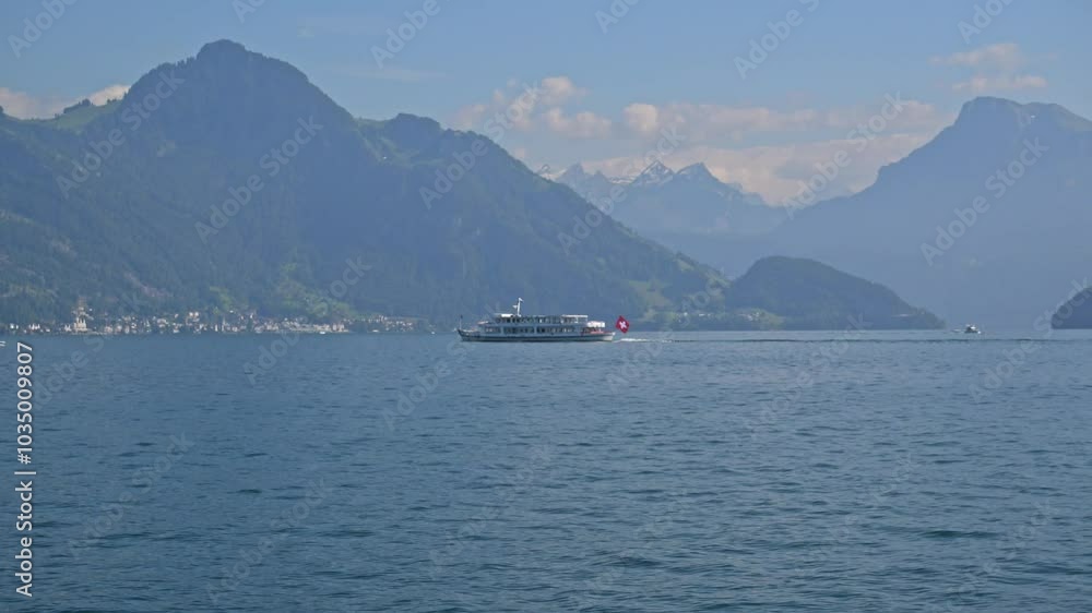 waves, mountains, and a Swiss flag flying ferry speed across Lake Lucerne, Switzerland waves, mountains, and a Swiss flag flying ferry speed across Lake Lucerne, Switzerland