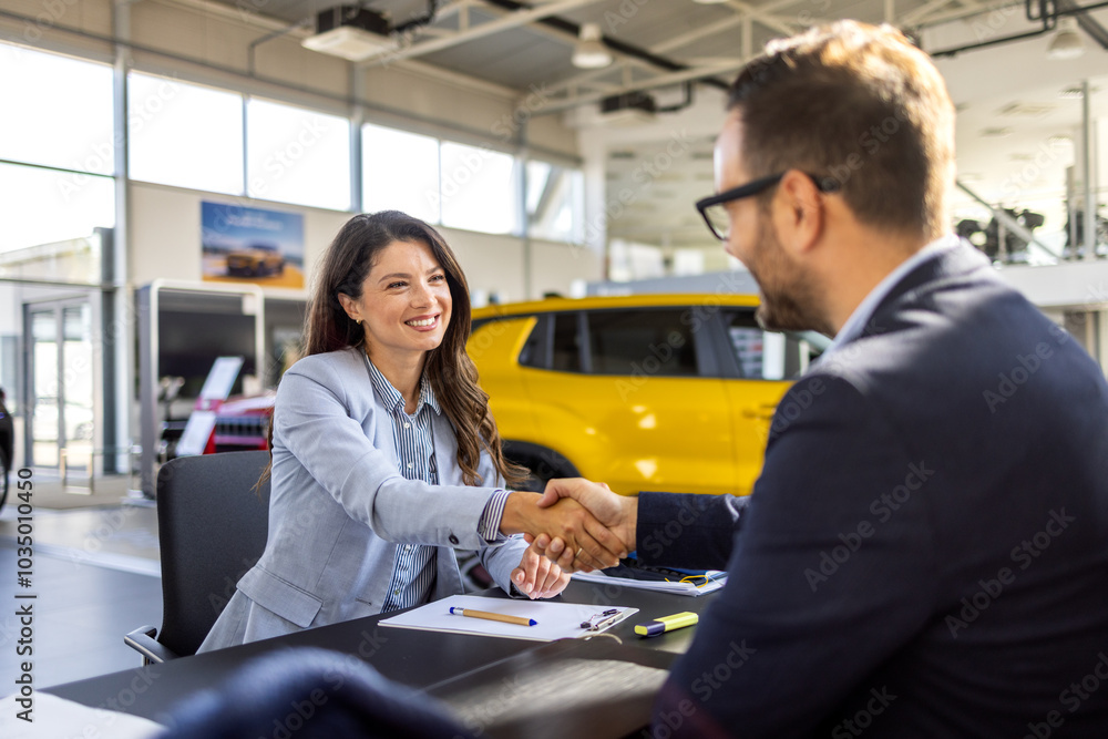 Fototapeta premium Car dealership, documents and people with handshake in showroom and contract, consulting and meeting. Man, woman and smile with legal agreement in sale for automobile, application and success in deal