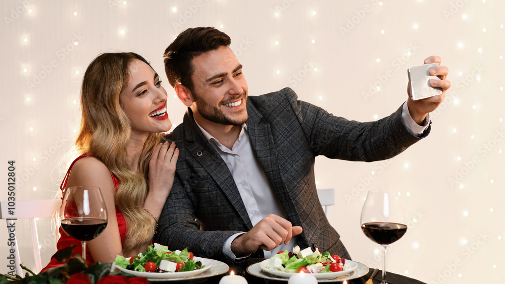Romantic Selfie. Loving Young Couple Taking Self-Portrait While Dining In Restaurant, Celebrating Valentine's Day Together, Free Space Romantic Selfie. Loving Young Couple Taking Self-Portrait While Dining In Restaurant, Celebrating Valentine's Day Together, Free Space