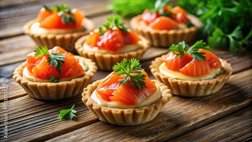 Tempting tartlets featuring fresh red salmon are beautifully showcased on a weathered wooden surface, creating an enticing visual feast that beckons food lovers to indulge.